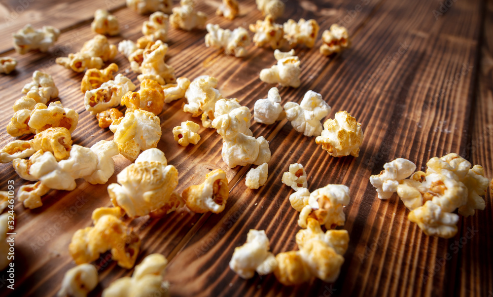 Fototapeta premium Popcorn flakes on a wooden background