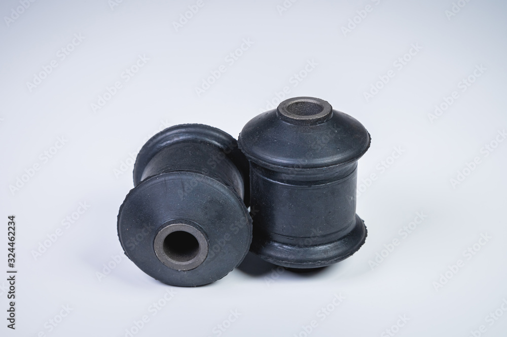 Classic silent blocks car suspension kit one pair on a gray background. Rubber parts with metal bushings Classic silent blocks car suspension kit one pair on a gray background. Rubber parts with metal bushings