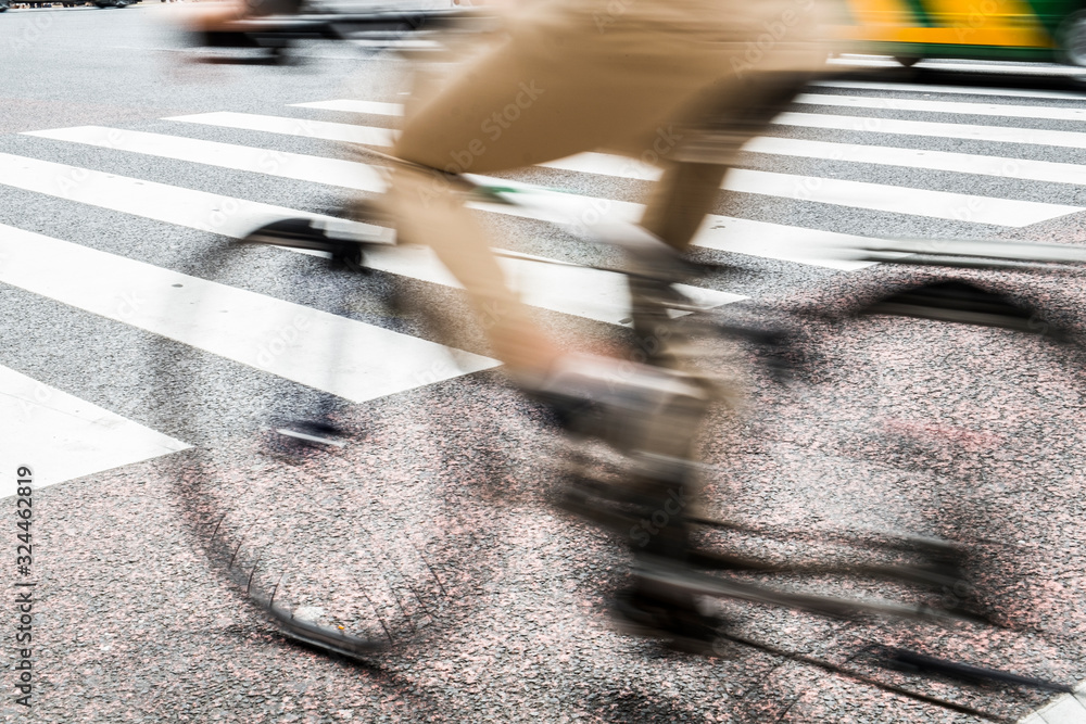 Obraz premium Motion blurry image man riding bicycle on the road