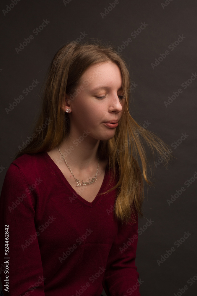 portrait of a girl in the Studio with painted blonde hair, in a red sweater portrait of a girl in the Studio with painted blonde hair, in a red sweater