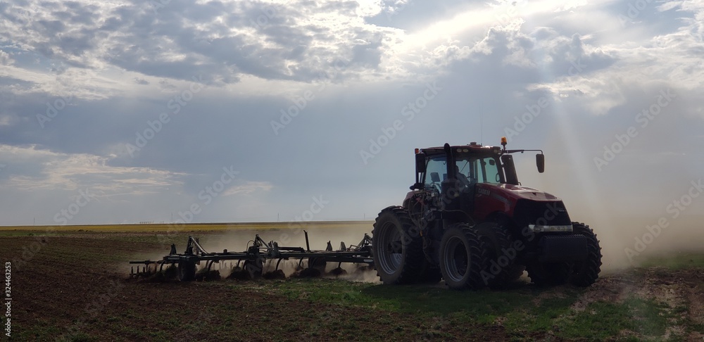 Fototapeta premium tractor plowing field
