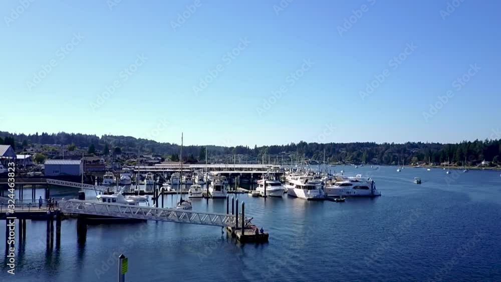 descending aerial shot towards a person diving off a dock in Gig Harbor, Washington, USA descending aerial shot towards a person diving off a dock in Gig Harbor, Washington, USA