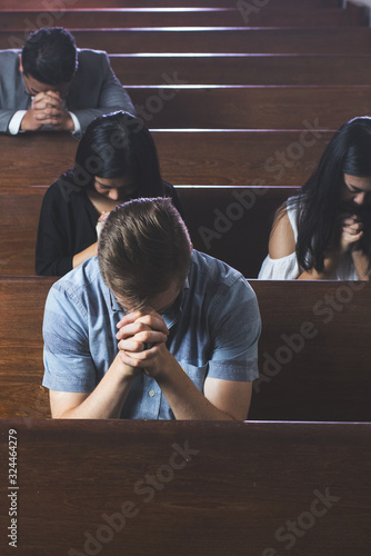 Group of people praying in church photo