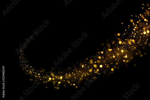 Gold glittering light bokeh abstract particles in dark background.