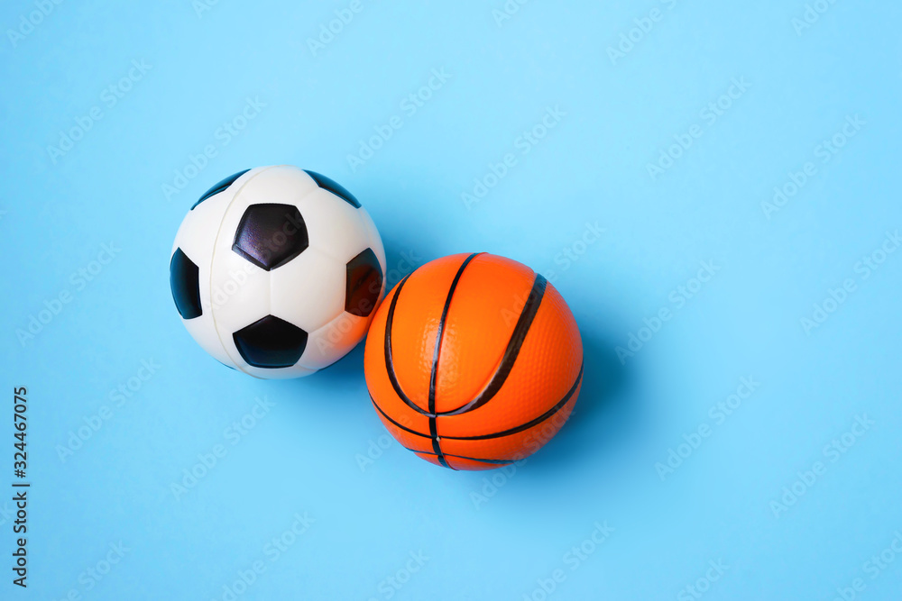 Miniature of a football and basketball on a blue background. Physical development of the child. Development center. How much does health cost? Miniature of a football and basketball on a blue background. Physical development of the child. Development center. How much does health cost?