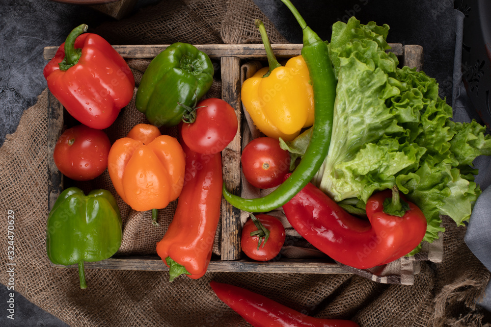 Chilies and lettuce in a wooden tray. Top view. Chilies and lettuce in a wooden tray. Top view.