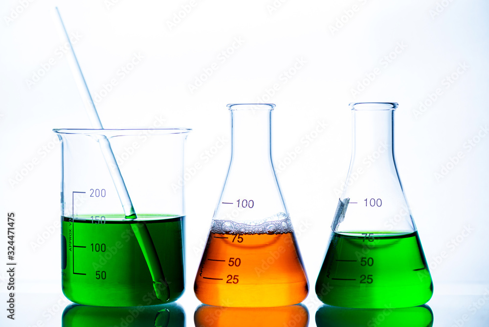 chemical liquid containing in flask with lab glassware on white background, lab research and development concept. chemical liquid containing in flask with lab glassware on white background, lab research and development concept.