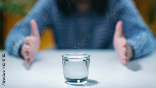 Telekinesis – Practicing Telekinetic Powers with Glass of Water photo