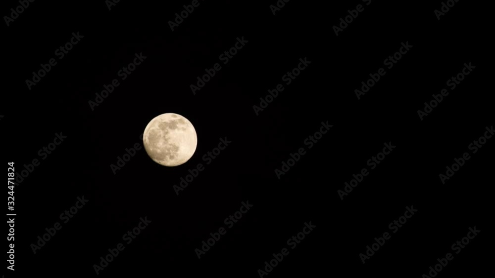 The full moon slowly moving across a clear black sky, mystical, golden glow The full moon slowly moving across a clear black sky, mystical, golden glow