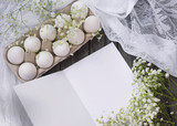 Happy Easter. White eggs in a stand on a wooden background with white gypsophila flowers. Holidays concept. Trend.
