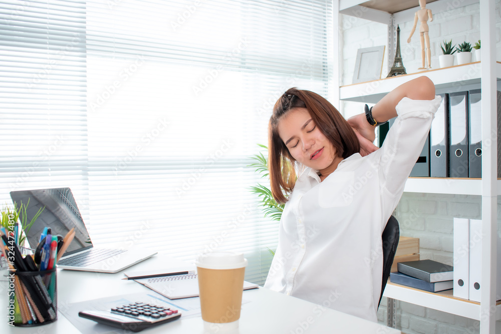 Φωτογραφία Asian businesswoman wears a white shirt stretching back and feels relaxed at the