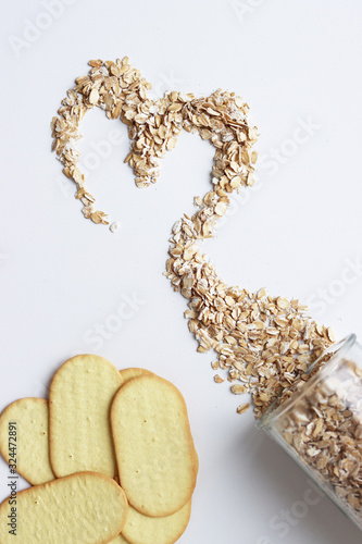 scattered oatmeal in the shape of a heart on a white background. Valentine's day from cereals