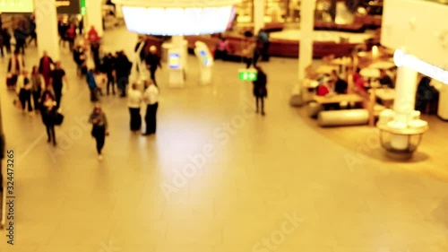 Blurred out of focus video of passengers walking in the airport terminal