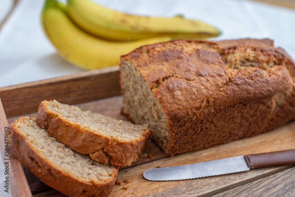 Banana Bread Loaf Sliced On Wooden Table Banana Bread Loaf Sliced On Wooden Table