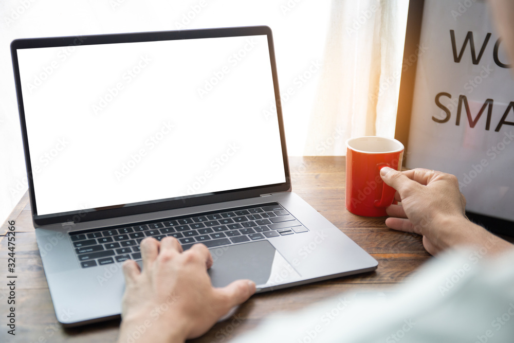 mockup image blank screen computer with white background for advertising text,hand man using laptop contact business search information on desk at home office.marketing and creative design mockup image blank screen computer with white background for advertising text,hand man using laptop contact business search information on desk at home office.marketing and creative design