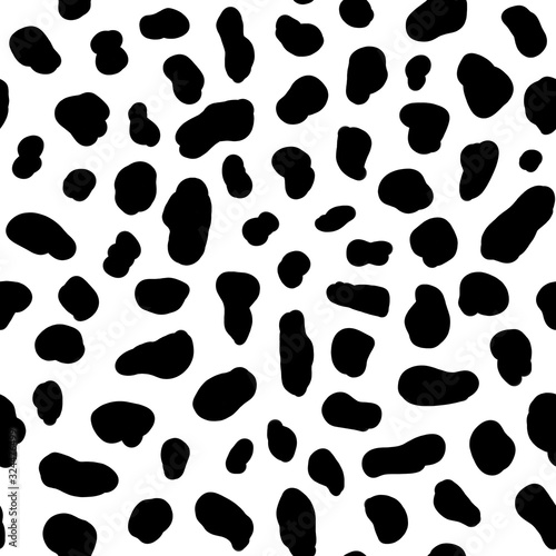 Black spots on a white background. Animal print. Spots of a cow and dolmatins. Seamless pattern for fabric, for wallpaper, for paper, for plastic and other surfaces.