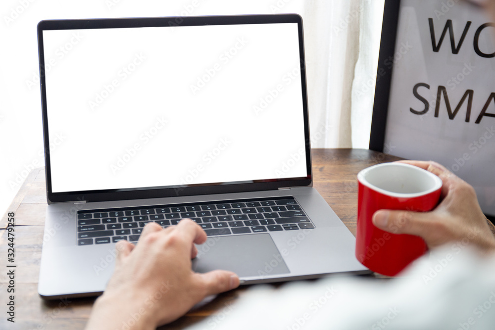 mockup image blank screen computer with white background for advertising text,hand man using laptop contact business search information on desk at home office.marketing and creative design mockup image blank screen computer with white background for advertising text,hand man using laptop contact business search information on desk at home office.marketing and creative design