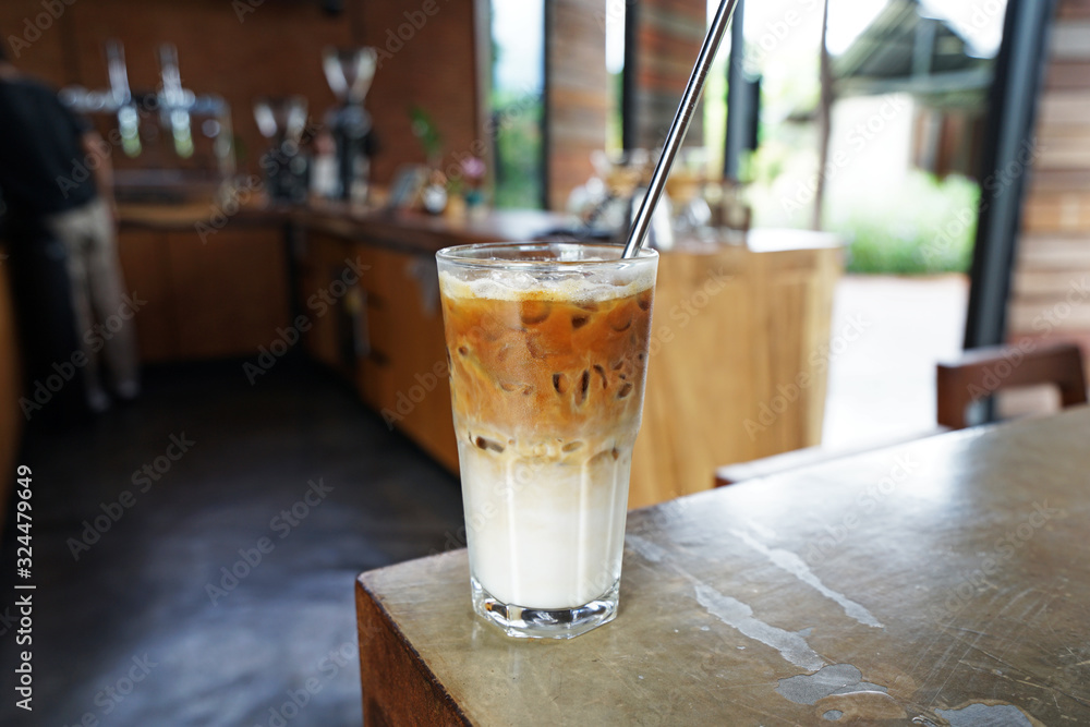 Close up glass of Iced latte coffee with stainless steel straw