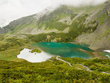 Alpine turquoise lake of Sofia, surrounded by rocks. Karachay-Cherkessia, Arkhyz. Russia.