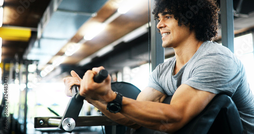 Portrait of healthy fit man working out in gym