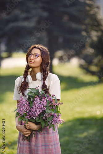 Woman with Bouquet of Flowers Outdoors in the City Park