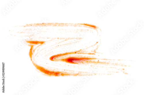 Smeared barbecue sauce or ketchup isolated on white background, close up, macro. Flat lay, top view.