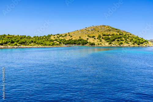 Adriatic coastline with rocky beach, island in the blue sea, Croatia, Dalmatia © alicja neumiler