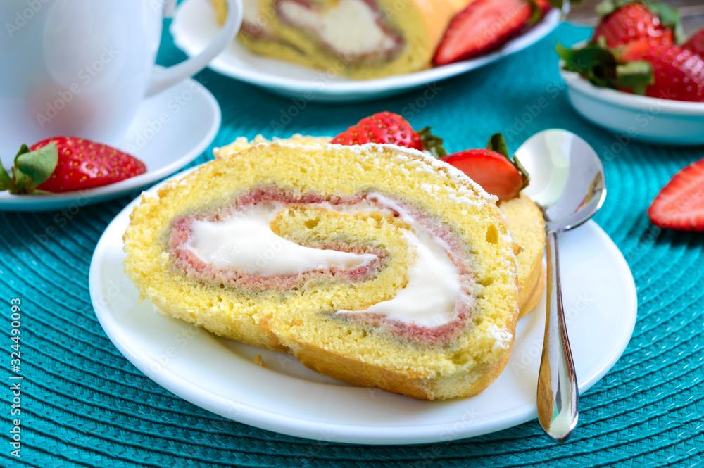 Sweet biscuit roll with strawberries and cream on a wooden background Sweet biscuit roll with strawberries and cream on a wooden background