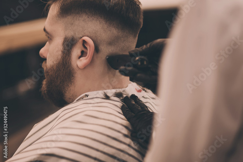 Young hipster man visiting barbershop