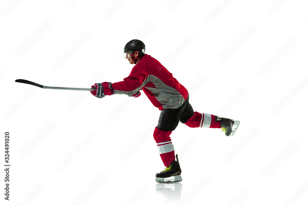 Obraz premium Leader. Male hockey player with the stick on ice court and white background. Sportsman wearing equipment and helmet practicing. Concept of sport, healthy lifestyle, motion, movement, action.