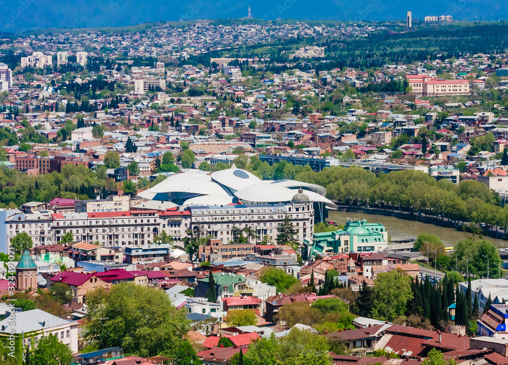 Panoramic view of Tbilisi city from Sololaki Hil, old town and modern architecture. Public Service Hall. Georgia