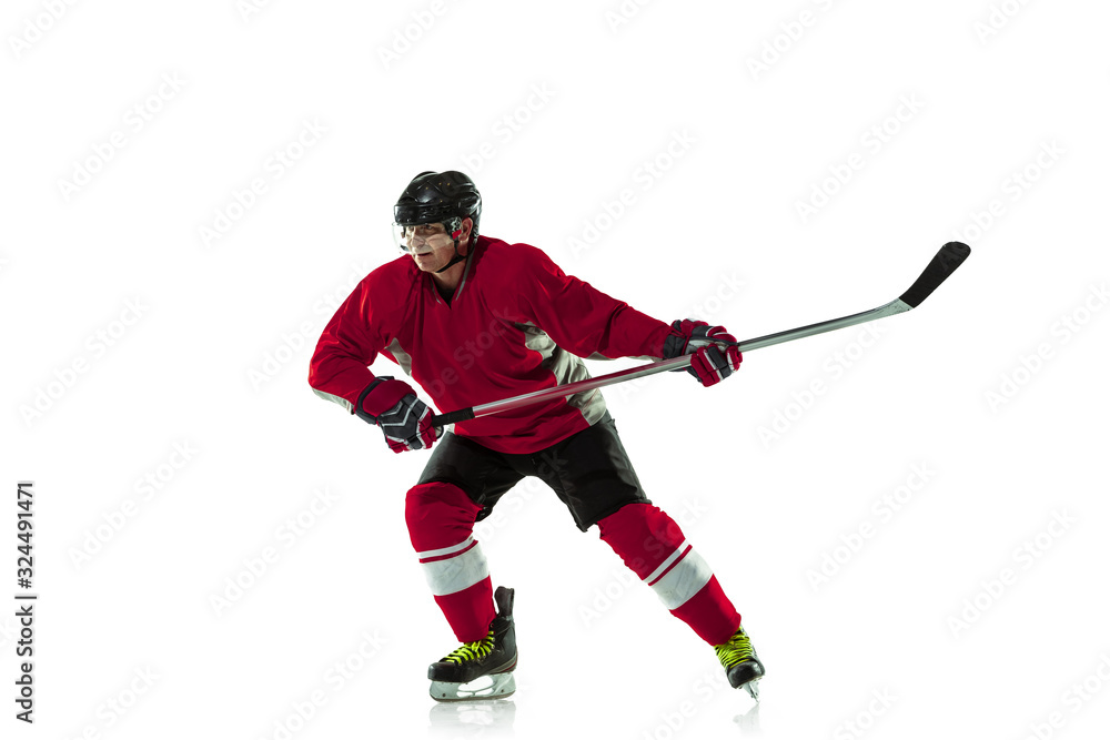 Leader. Male hockey player with the stick on ice court and white background. Sportsman wearing equipment and helmet practicing. Concept of sport, healthy lifestyle, motion, movement, action. Leader. Male hockey player with the stick on ice court and white background. Sportsman wearing equipment and helmet practicing. Concept of sport, healthy lifestyle, motion, movement, action.