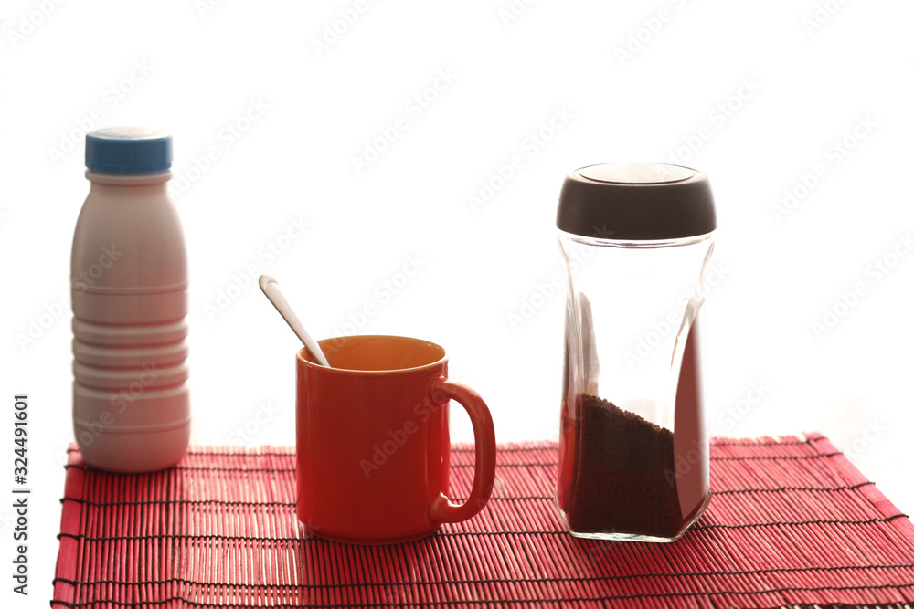 breakfast concept: cofee cup, soluble coffe container and milk bottle on white background with copy space for your text breakfast concept: cofee cup, soluble coffe container and milk bottle on white background with copy space for your text