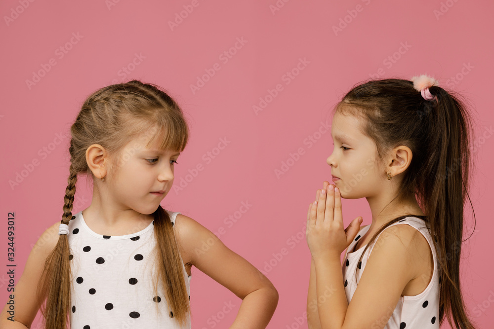 the two girlfriends quarreled. one girl is offended, and the second apologizes.