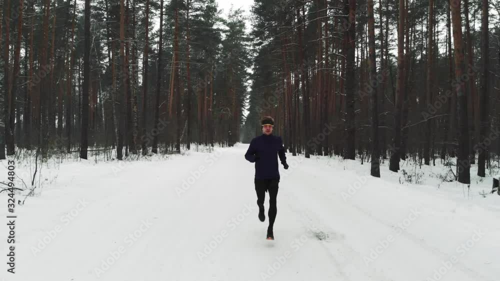 Running Man In Sportswear Workout Before Triathlon.Winter Sports Concept. Aerial Running Man In Sportswear Workout Before Triathlon.Winter Sports Concept. Aerial