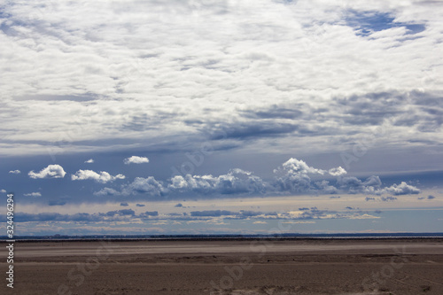 heavy rain cloudy sky over a sandy desert against the backdrop of the city