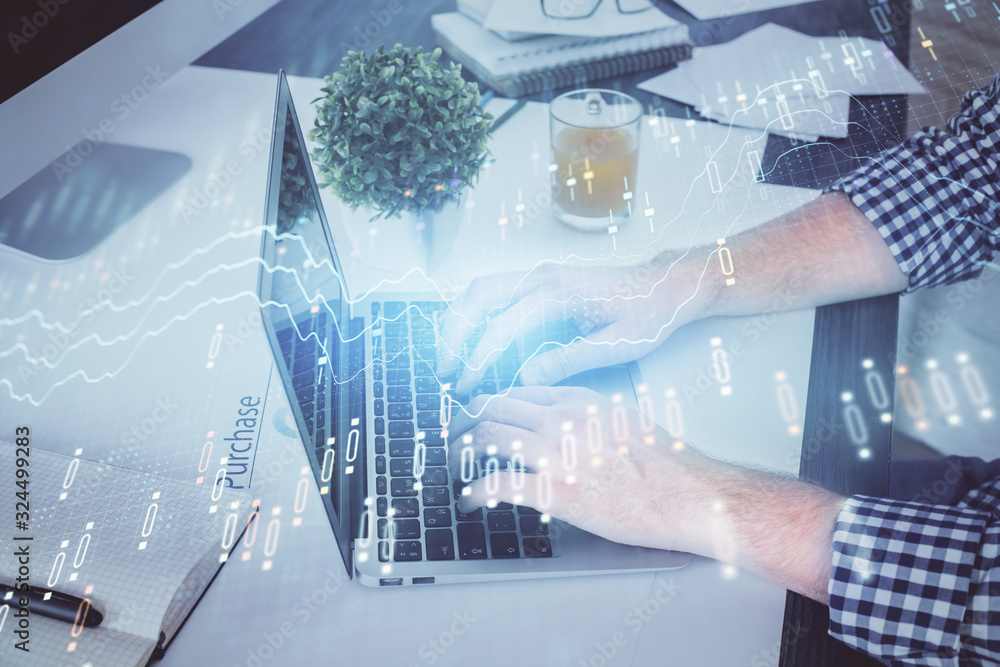Double exposure of graph with man typing on computer in office on background. Concept of hard work. Double exposure of graph with man typing on computer in office on background. Concept of hard work.