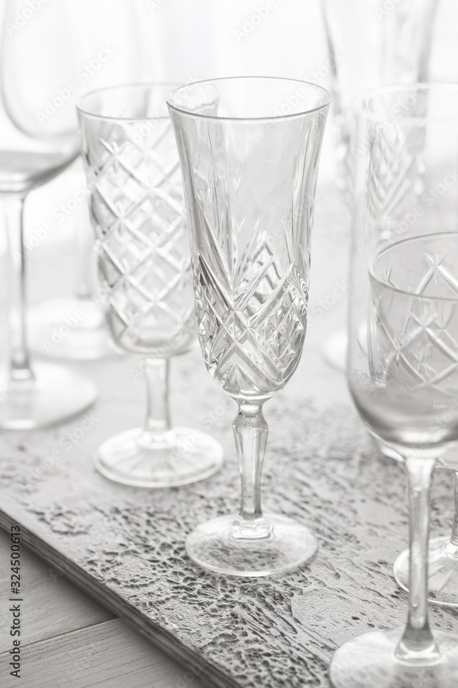 Empty champagne glasses in white grey shades on concrete background.
