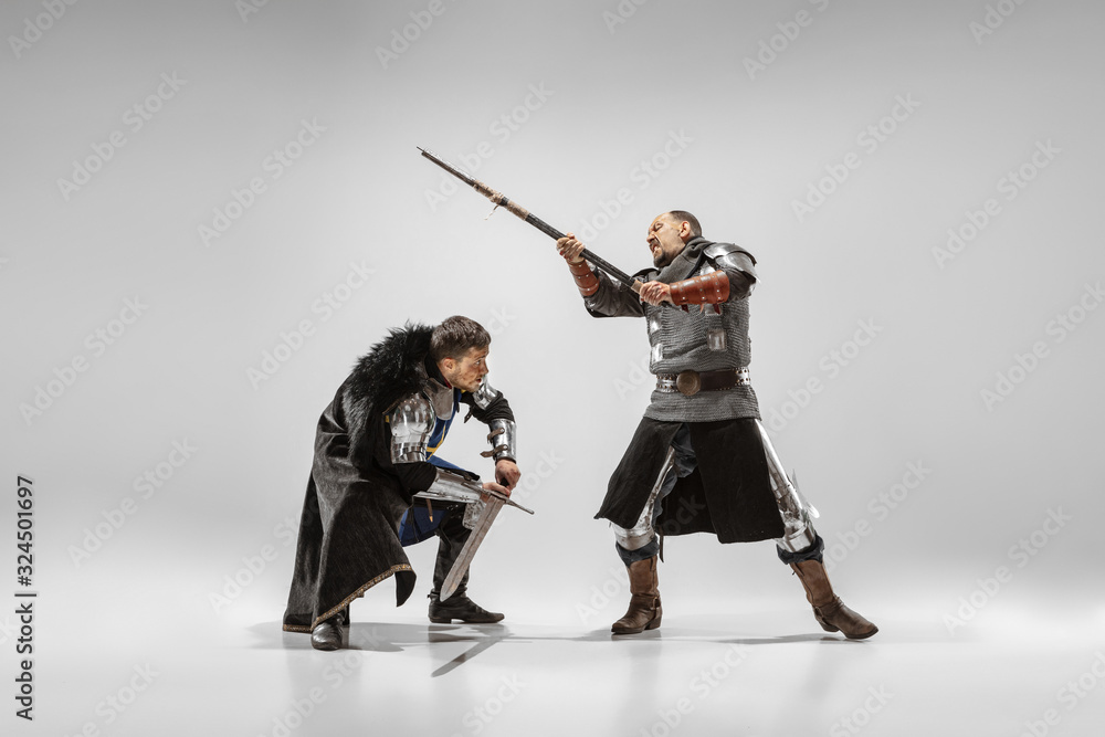 Brave armored knights with professional weapon fighting isolated on ...