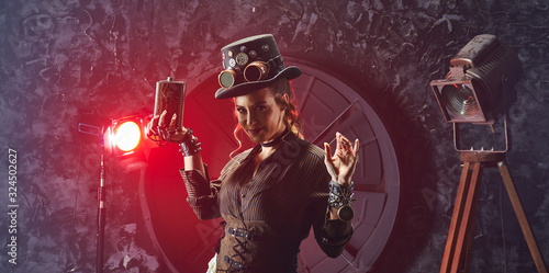 Portrait of a beautiful steampunk girl with watch and flask