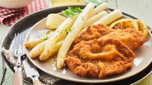 White asparagus tips served with crumbed schnitzel