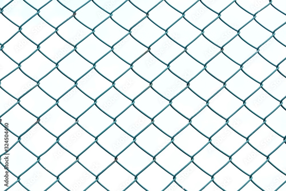 Close up green square wire mesh chain link fence against white sky for background texture Close up green square wire mesh chain link fence against white sky for background texture