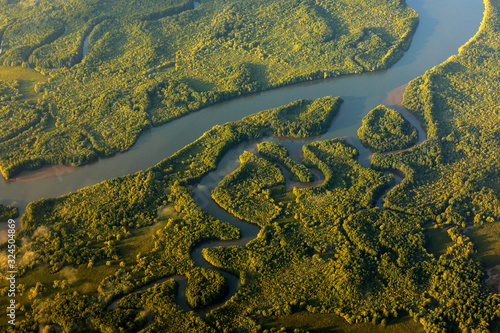 River in tropic Costa Rica, Corcovado NP. Lakes and rivers, view from airplane. Green grass in Central America. Trees with water in rainy season. Photo from air. photo