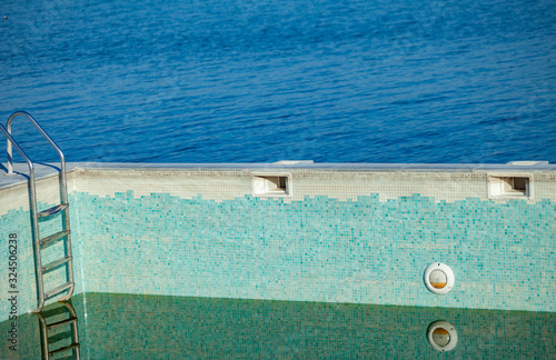 Empty pool and the sea in the background