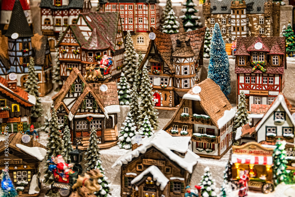 Obraz premium Toy Christmas ceramic miniature with snow-covered city. Small festive village in Berlin, Germany