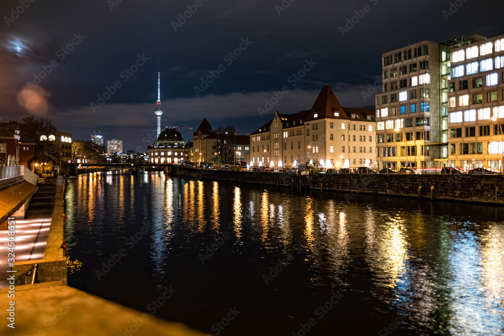 View of Museum Island with famous TV tower and Spree river in center of Berlin at night