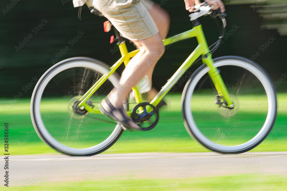 Fototapeta premium Riding bicycle - blurred motion, fast driving.