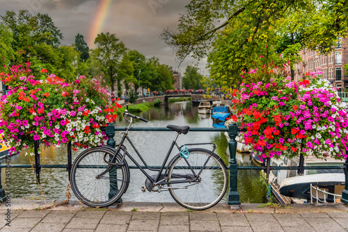 Bicycle on a Bridge over a Canal in Amsterdam Netherlands with Rainbow