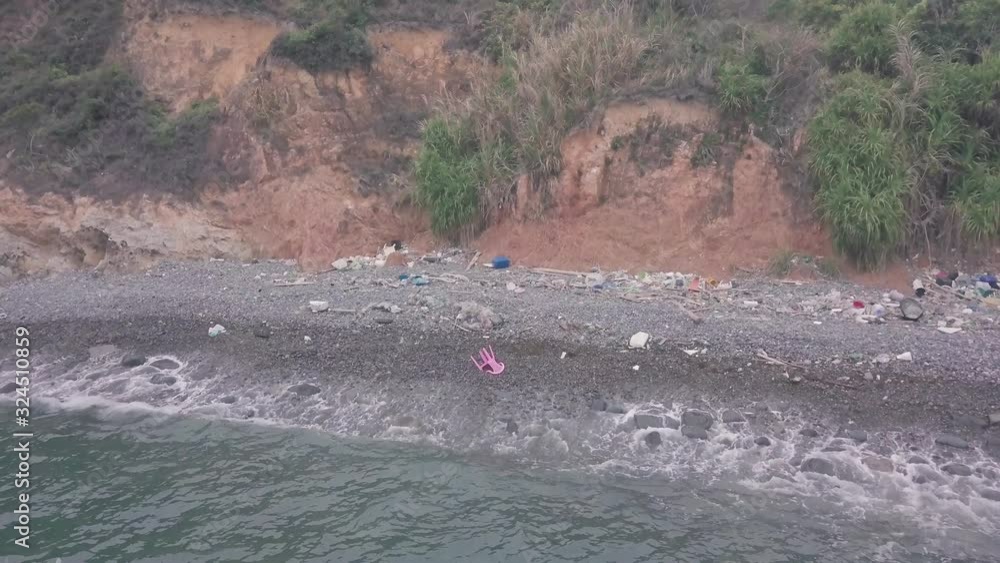 Broken plastic chair washed up on beach in Hong Kong. Aerial drone view Broken plastic chair washed up on beach in Hong Kong. Aerial drone view
