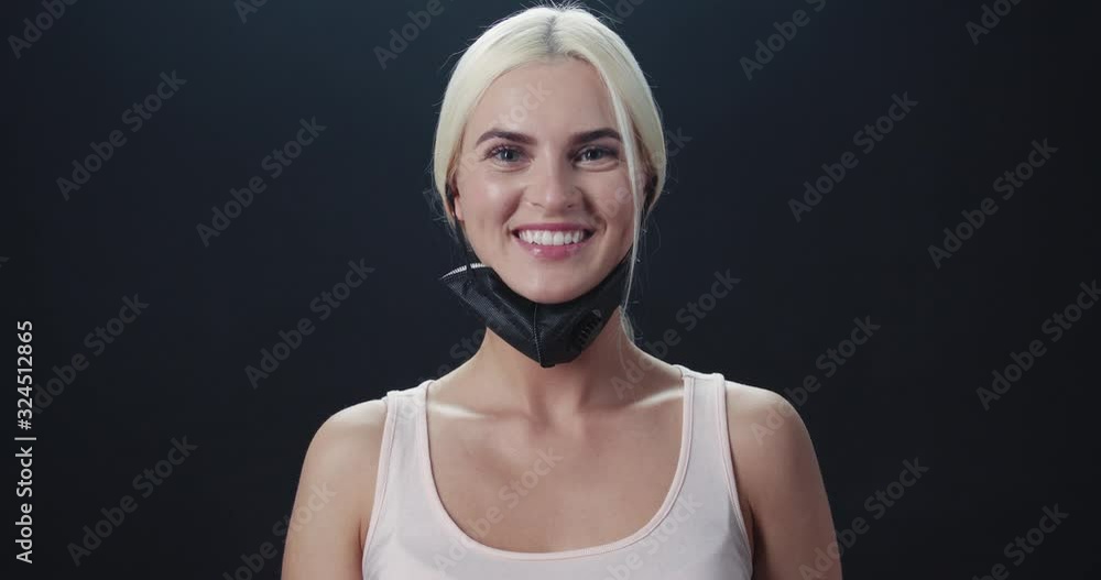 Young woman removes the protective mask and looking at the camera, Chinese coronavirus, epidemic of infection, protected from the virus, portrait of a woman. Young woman removes the protective mask and looking at the camera, Chinese coronavirus, epidemic of infection, protected from the virus, portrait of a woman.